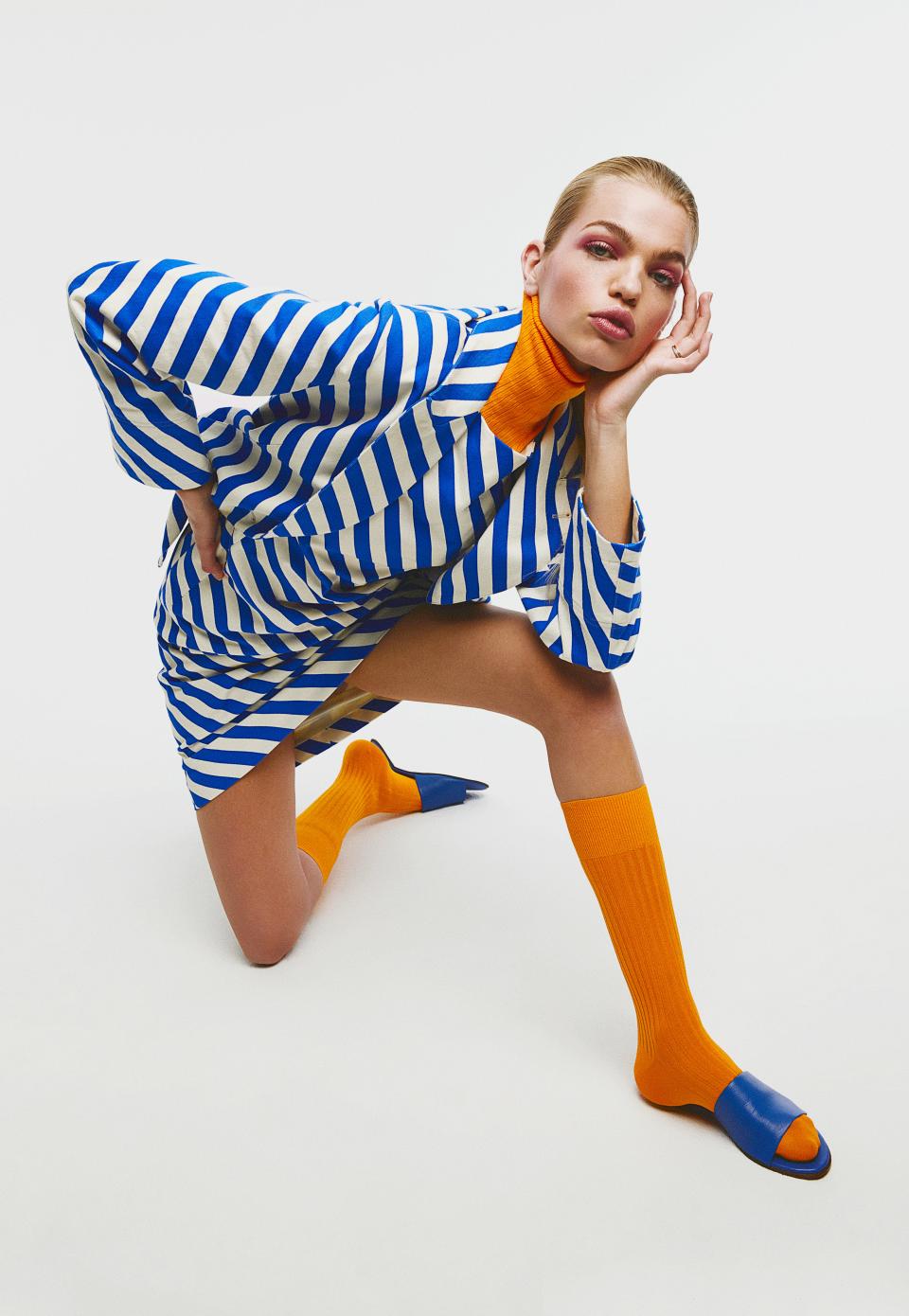 <cite class="credit">Jacket, and dress, by Dries Van Noten / Turtleneck, and sandals, by Simon Miller / Socks, by London Sock Co. / Ring, her own</cite>