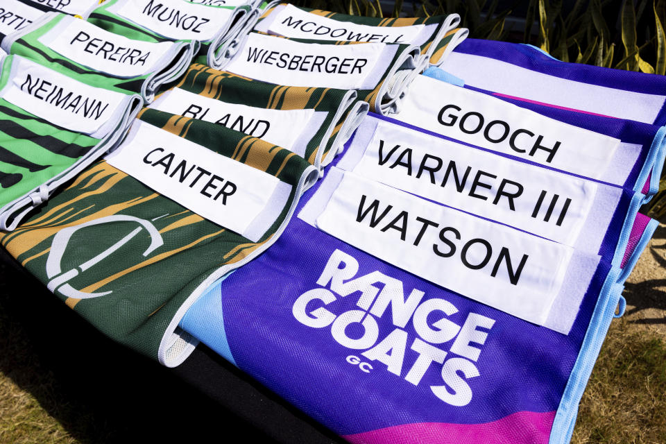 The Cleeks GC and RangeGoats GC LIV Golf team caddie bibs shown on the driving range during the first round of the LIV Golf Mayakoba at El Camaleón Golf Course, Friday, Feb. 24, 2023, in Playa del Carmen, Mexico. (Chris Trotman/LIV Golf via AP)