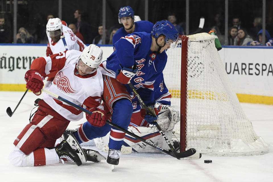 Detroit Red Wings center Christoffer Ehn (70) works with the puck next to New York Rangers defenseman Ryan Lindgren (55) during the third period of an NHL hockey game Friday, Jan. 31, 2020, in New York. (AP Photo/Sarah Stier)