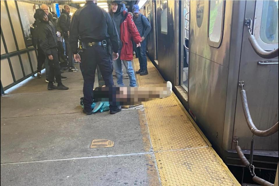 A shooting victim lies on the platform at the Mt. Eden Avenue Station. Brendan SmythFacebook