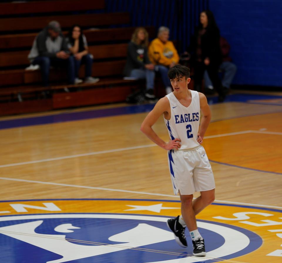 Lincoln senior Alex Bertsch looks on as a teammates shoots free throws Dec. 4, 2021. Bertsch made four 3-pointers in the first half and fouled out with two minutes left in the game.