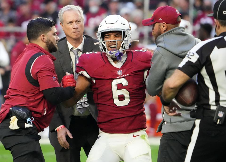 Jan 9, 2022; Glendale, Arizona, USA; Arizona Cardinals running back James Conner (6) reacts after being helped off the field for an injury against the Seattle Seahawks in the second half at State Farm Stadium. Mandatory Credit: Rob Schumacher-Arizona Republic