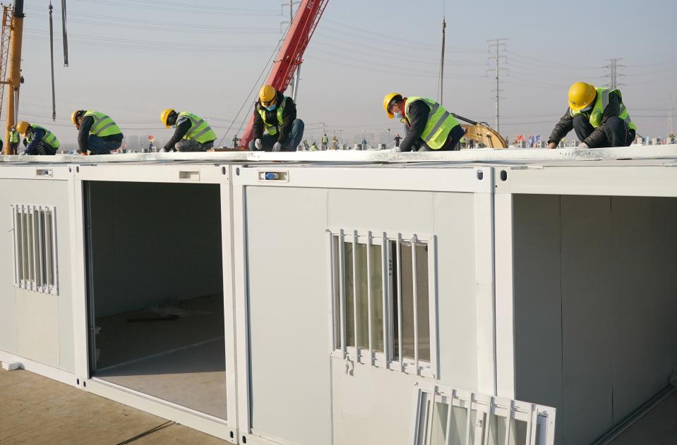 SHIJIAZHUANG, Jan. 18, 2021 -- Workers build the Huangzhuang apartment COVID-19 quarantine center in Shijiazhuang, north China's Hebei Province, Jan. 18, 2021.   Construction of the main structures of the Huangzhuang apartment COVID-19 quarantine center in Shijiazhuang is nearing the end. With a total floor area of 34 hectares, the facility will house close contacts or secondary close contacts of COVID-19 confirmed cases. (Photo by Yang Shiyao/Xinhua via Getty) (Xinhua/Yang Shiyao via Getty Images)