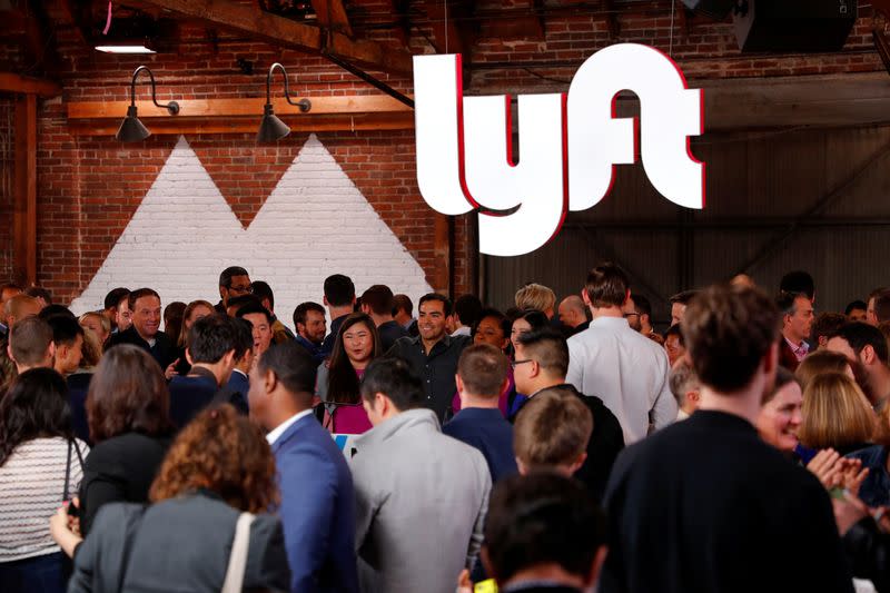 FILE PHOTO: People mingle following the 2019 listing of Lyft on the Nasdaq at an event in Los Angeles