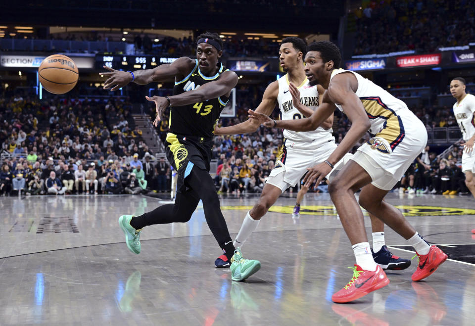 Indiana Pacers forward Pascal Siakam (43) passes the ball away from New Orleans Pelicans guard Trey Murphy III, middle, and forward Herbert Jones during the first half of an NBA basketball game Wednesday, Feb. 28, 2024, in Indianapolis. (AP Photo/Marc Lebryk)