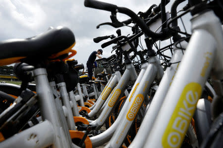 Zhivko Girginov, a Bulgarian living in Singapore, loads up damaged shared bicycles on his lorry to return them to a warehouse after gathering them around his neighbourhood in Singapore December 29, 2017. REUTERS/Edgar Su