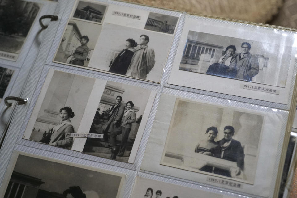 Photos of Zeng Fanzhi, a retired architect turned artist, during his time as an architect on a team designing Beijing's Tiananmen Square, sit in an album in Zeng's apartment in Shenzhen in southern China's Guangdong province, Friday, Oct. 27, 2023. Zeng painted stark, realist portrayals of life in China under zero-COVID, saying he did so to capture a unique moment in history. (AP Photo/Dake Kang)