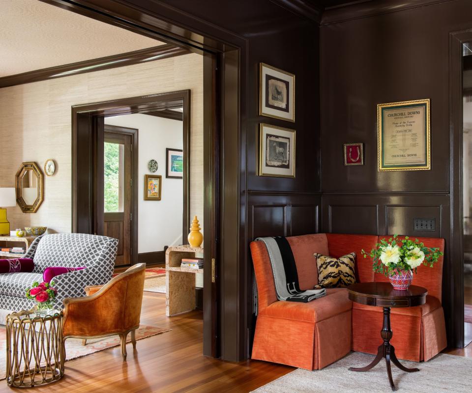 Orange sofa, brown wooden table and walls