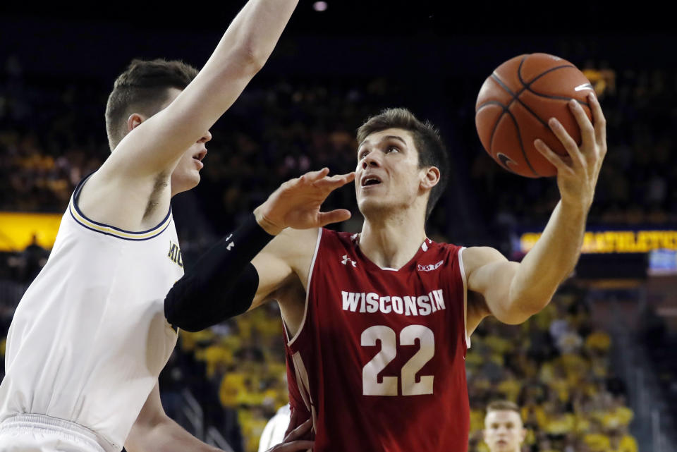 Wisconsin forward Ethan Happ (22) looks to shoot as Michigan center Jon Teske defends during the first half of an NCAA college basketball game, Saturday, Feb. 9, 2019, in Ann Arbor, Mich. (AP Photo/Carlos Osorio)