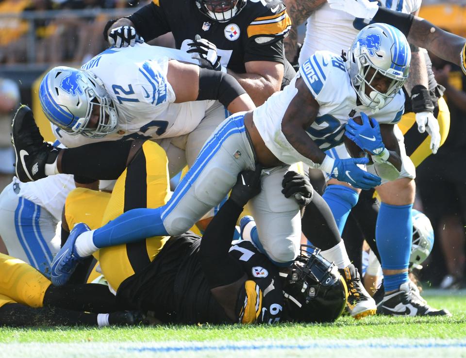Aug 28, 2022; Pittsburgh, Pennsylvania, USA;  Detroit Lions running back Jermar Jefferson (28) is upended by Pittsburgh Steelers defensive tackle Larry Ogunjobi (65) during the first quarter at Acrisure Stadium.