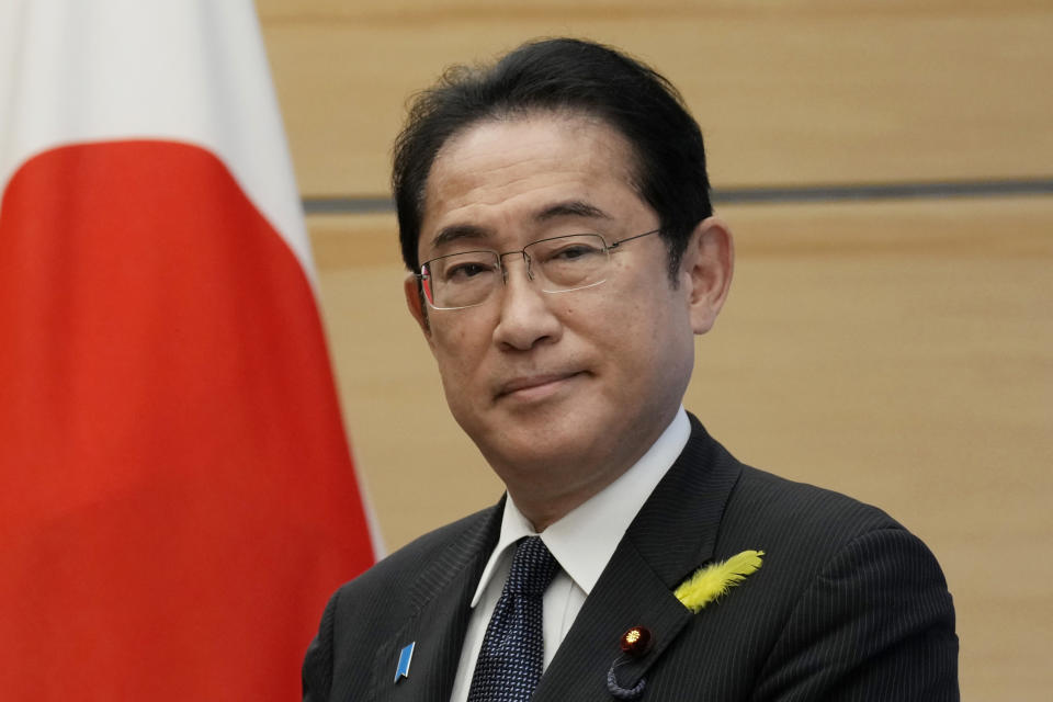 FILE - Japanese Prime Minister Fumio Kishida is presented the International Atomic Energy Agency's comprehensive report on Fukushima treated water release by IAEA Director General Rafael Mariano Grossi at the prime minister's office in Tokyo, on July 4, 2023. Japan stepped up its alarm over China's assertiveness in the region, its growing military ties to Russia and its claims on Taiwan in an annual defense paper released Friday, July 28, 2023 that is the first under Tokyo's new security strategy calling for a major military buildup. (AP Photo/Eugene Hoshiko, Pool, File)