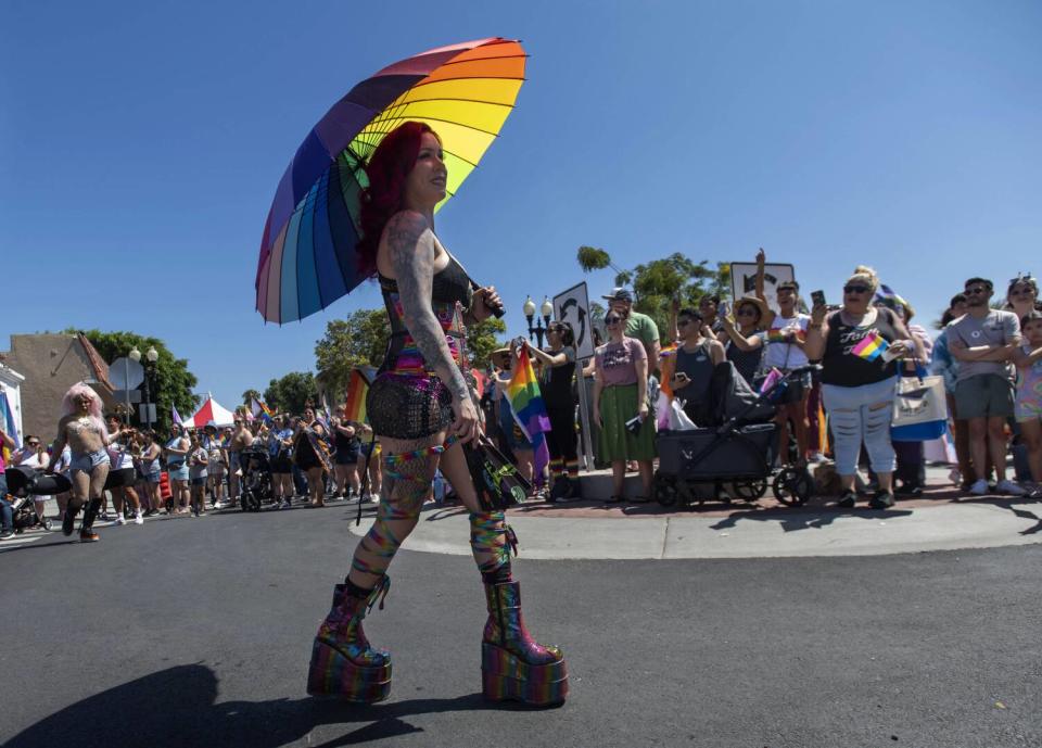 Spectators take photos during this year's OC Pride parade.