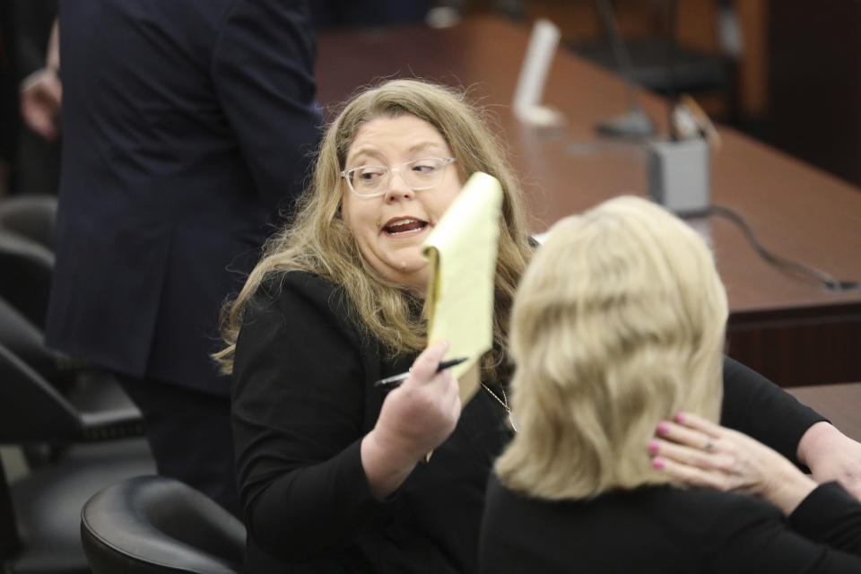 Attorney Kathleen McDaniel speaks to another attorney before a hearing asking a judge to halt enforcement of the state's new law banning abortion when cardiac activity is detected during a hearing Friday, May 26, 2023, in Columbia, South Carolina. (AP Photo/Jeffrey Collins)