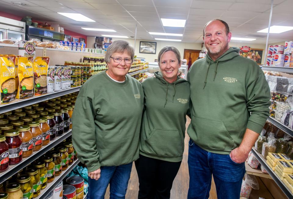 Dave Hughs, right, Keri Hughs, middle, and Keri's mother Mary Beecham pose in the specialty items section of Beecham's Market, 131 S. Sampson Street, in Tremont. Beecham's Market is celebrating its 100th anniversary.