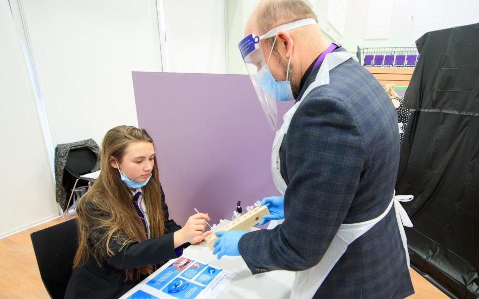 A student takes a lateral flow test at Outwood Academy in Doncaster, Yorks - PA