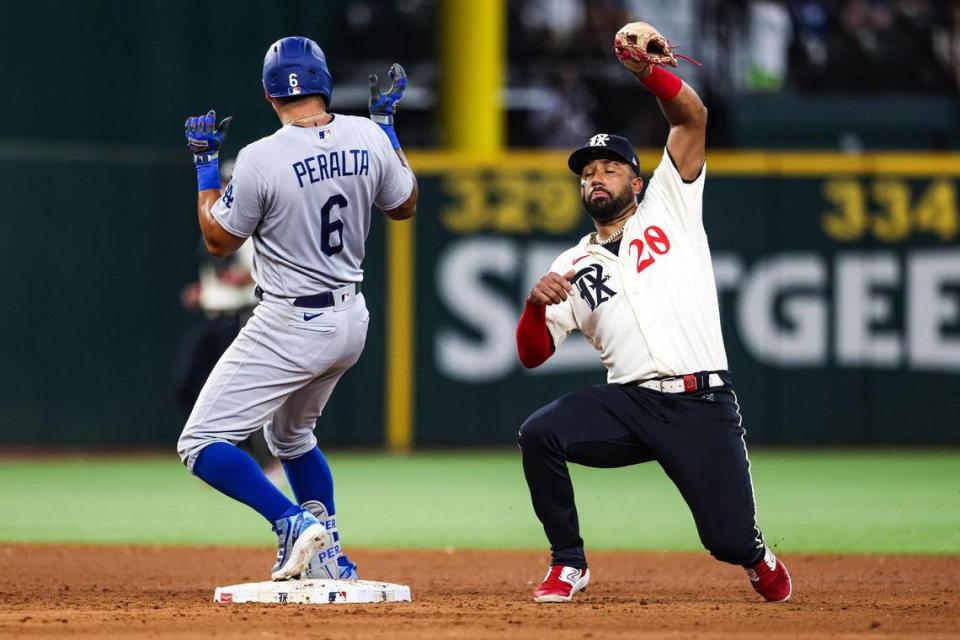 Los Angeles Dodgers outfielder David Peralta (6) reaches second base on a double before Texas Rangers infielder Ezequiel Duran (20) could tag him in the eighth inning of a regular season game at Globe Life Field in Arlington, Texas on Saturday, July 22, 2023.