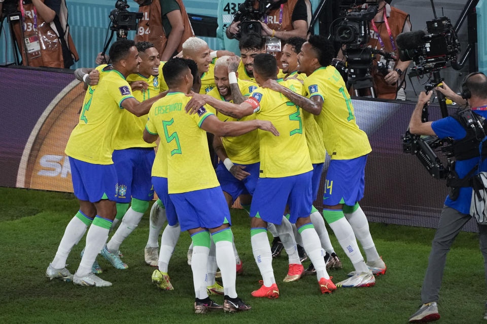 Brazil's Neymar, center, celebrates his penalty kick goal with teammates during the World Cup round of 16 soccer match between Brazil and South Korea, at the Education City Stadium in Al Rayyan, Qatar, Monday, Dec. 5, 2022. (AP Photo/Ariel Schalit)