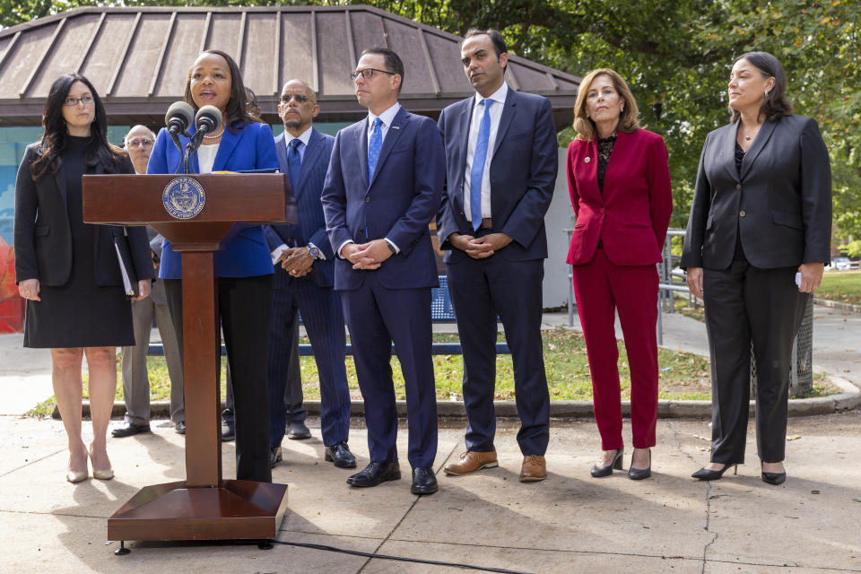 Kristen Clarke, at podium, Assistant Attorney General for the Justice Department's Civil Rights Division, is joined with, from left, New Jersey First Assistant Attorney General Lyndsay Ruotolo, Pennsylvania state Sen. Vincent Hughes, Pennsylvania Attorney General Josh Shapiro, Rohit Chopra, CFPB Director, Delaware Attorney General Kathy Jennings and Jacqueline C. Romero, United States Attorney for the Eastern District of Pennsylvania during a press conference at Malcolm X Park, Wednesday morning. July 27, 2022, West Philadelphia, Pa. Trident Mortgage Co., a division of Warren Buffett's Berkshire's HomeServices of America, discriminated against potential Black and Latino homebuyers in Philadelphia, New Jersey and Delaware, the Department of Justice said Wednesday, in what they are calling the second-largest redlining settlement in history. (Alejandro A. Alvarez/The Philadelphia Inquirer via AP)