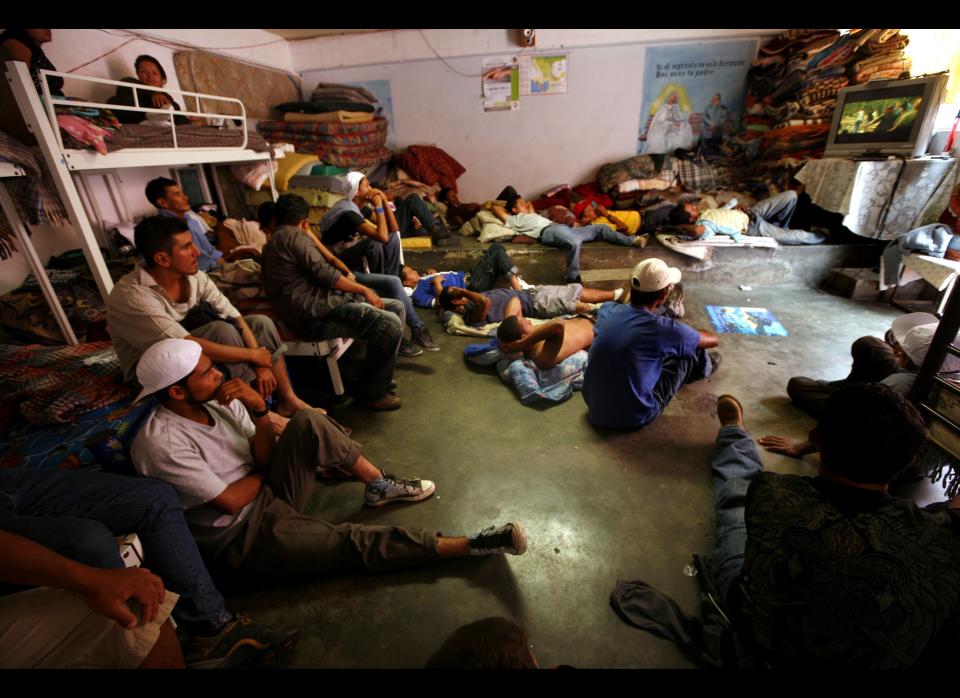 In this May 12, 2012 photo, Central American migrants watch television while waiting for a north bound train to continue their journey to the US-Mexico border, at a migrant shelter in Lecheria, on the outskirts of Mexico City. While the number of Mexicans heading to the U.S. has dropped dramatically, a surge of Central American migrants is making the 1,000-mile northbound journey this year, fueled in large part by the rising violence brought by the spread of Mexican drug cartels. (AP Photo/Marco Ugarte)