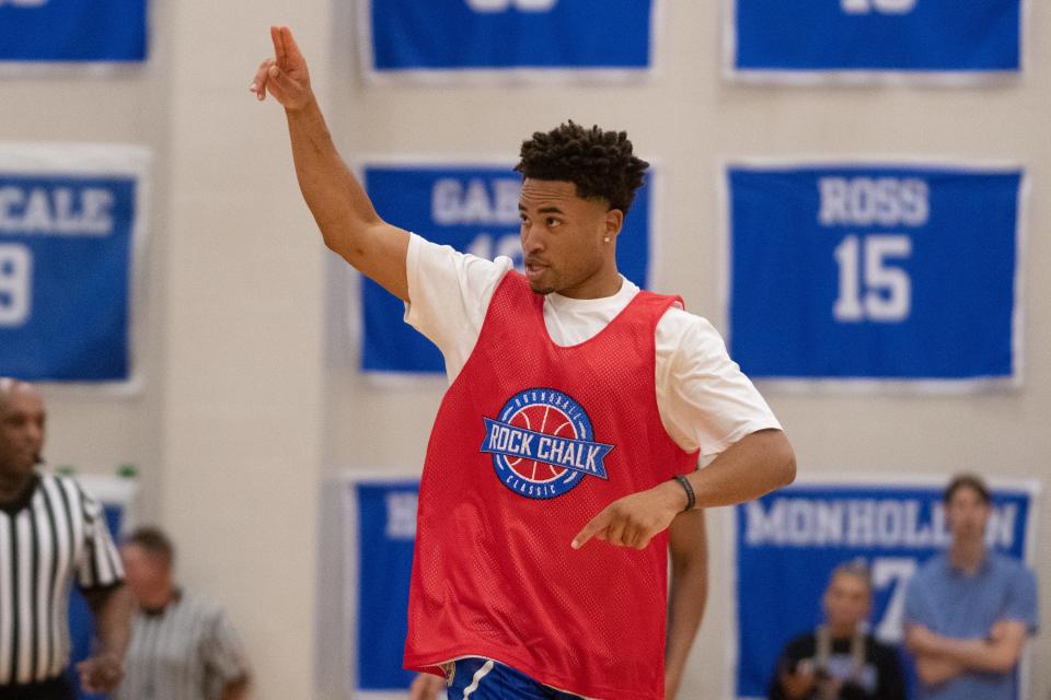 Devon Dotson salutes fans in attendance for Thursday's Rock Chalk Roundball Classic after sinking a 3-pointer during a charity exhibition.