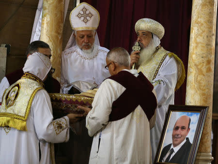 A picture of Medhat Michel, one of the Christian victims of the crashed EgyptAir flight MS804, is seen during an absentee funeral mass at the main Cathedral in Cairo, Egypt, May 22, 2016. REUTERS/Mohamed Abd El Ghany