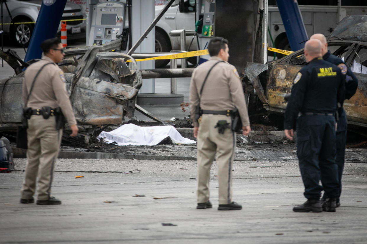 California Highway Patrol and other officials investigate a fiery crash where multiple people were killed near a Windsor Hills gas station at the intersection on Aug. 4, 2022 in Los Angeles County, California.  / Credit: Jason Armond / Los Angeles Times via Getty Images