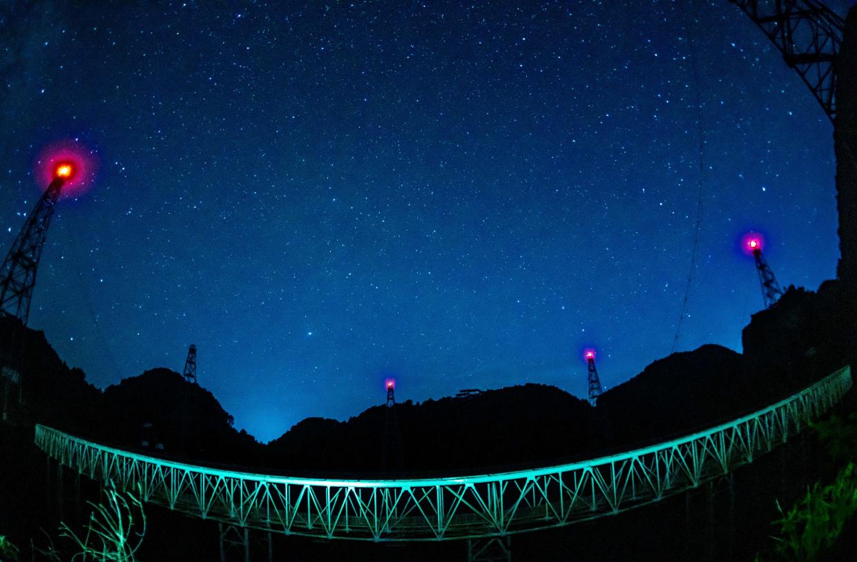 The long-time exposure photo taken on July 25, 2022 shows a night view of China's Five-hundred-meter Aperture Spherical Radio Telescope FAST under maintenance in southwest China's Guizhou Province.  Located in a naturally deep and round karst depression in southwest China's Guizhou Province, FAST started formal operation in January 2020 and officially opened to the world on March 31, 2021. It is believed to be the world's most sensitive radio telescope. With FAST, scientists have identified over 660 new pulsars. (Photo by Ou Dongqu/Xinhua via Getty Images)