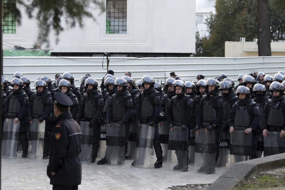 Riot police stand guard during an antigovernment rally in Tirana, Tuesday, Feb. 26, 2019. Albanian opposition supporters have surrounded the parliament building and are demanding that the government resign, claiming it's corrupt and has links to organized crime. (AP Photo/Hektor Pustina)