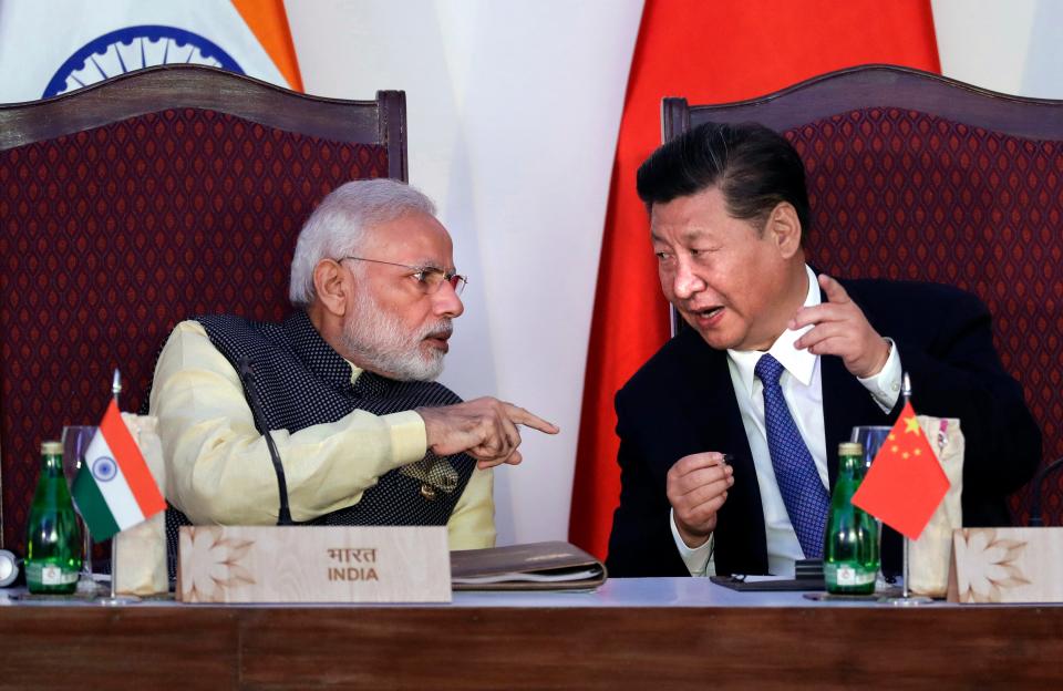 File:  Indian prime minister Narendra Modi, left, talks with Chinese president Xi Jinping at a signing ceremony by foreign ministers during the BRICS summit in Goa, India, 16 October 2016 (AP)