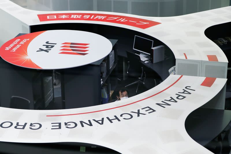 A staff member of the Tokyo Stock Exchange (TSE) is seen at the empty trading space after the TSE temporarily suspended all trading due to system problems in Tokyo