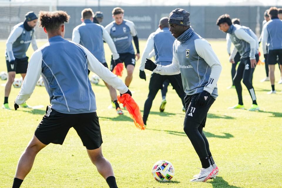 Crew midfielder Marino Hinestroza dribbles around forward Jacen Russell-Rowe during preseason training.