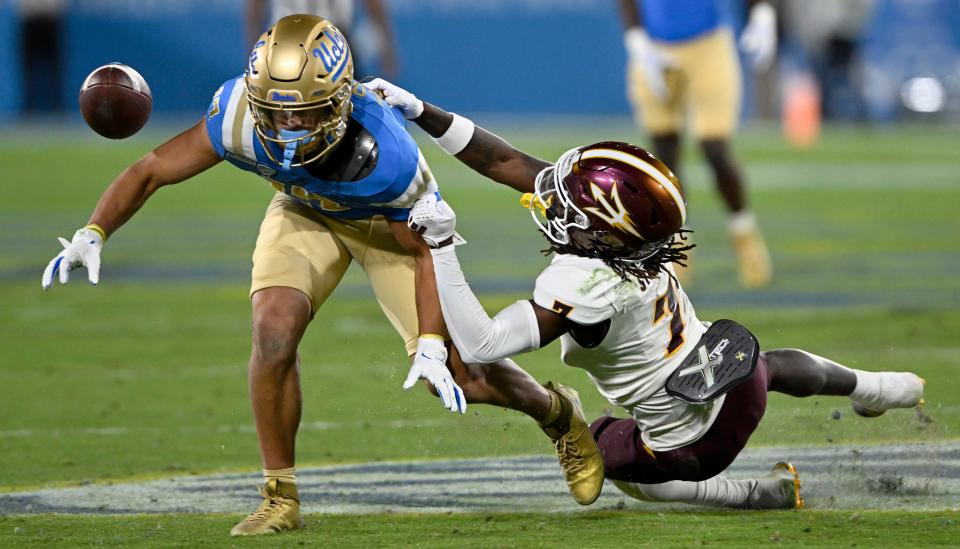 Arizona State defensive back Shamari Simmons (7) pulls down UCLA wide receiver Logan Loya (left) after knocking away the football during the first half at the Rose Bowl on Nov. 11, 2023, in Pasadena, California.