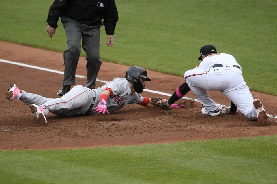 Boston Red Sox's Marwin Gonzalez, front left, is tagged out by Baltimore Orioles first baseman Ryan Mountcastle, right, on a pickoff during the third inning of a baseball game, Sunday, May 9, 2021, in Baltimore. (AP Photo/Nick Wass)