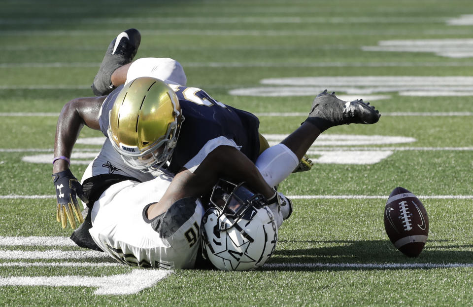 Notre Dame safety Jalen Elliott, top, tackles as Vanderbilt wide receiver Kalija Lipscomb misses the ball during the second half of an NCAA college football game in South Bend, Ind., Saturday, Sept. 15, 2018. Notre Dame won 22-17. (AP Photo/Nam Y. Huh)