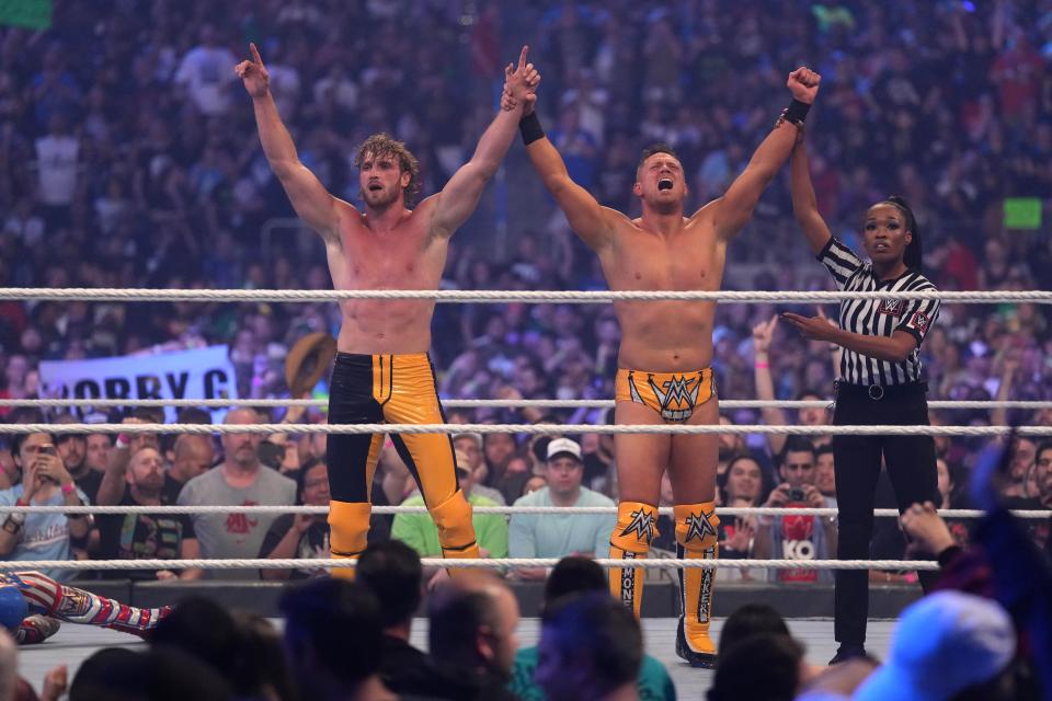 Logan Paul and the Miz celebrate after winning the tag team match against the Mysterios.