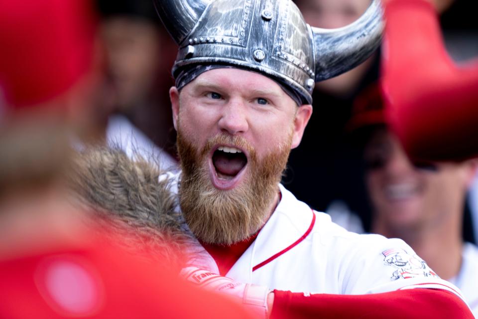 Cincinnati Reds left fielder Jake Fraley (27) smiles as he high fives teammates after hitting a solo home run in the sixth inning of the Baseball game between the Cincinnati Reds and the Arizona Diamondbacks at Great American Ball Park in Cincinnati on Saturday, July 22, 2023. 