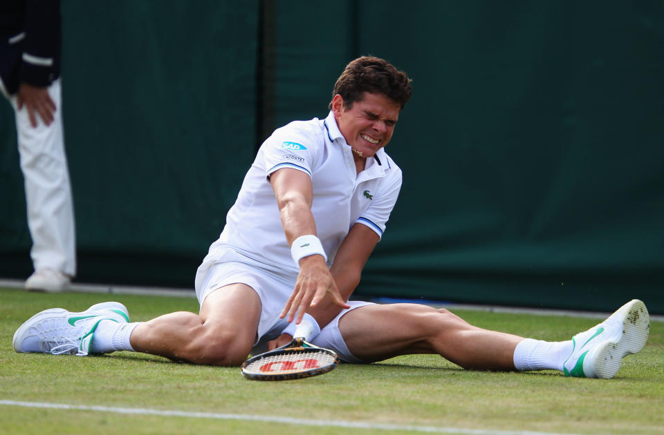 Milos Raonic of Canada falls down during his second round match against Gilles Muller of Luxembourg at Wimbledon in 2011. He ended up having hip surgery. (Photo by Julian Finney/Getty Images)