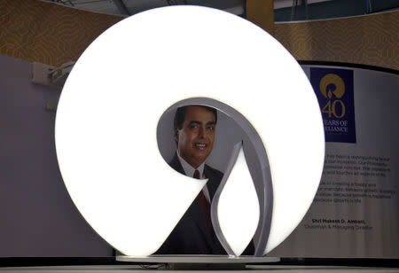 FILE PHOTO: The logo of Reliance Industries is pictured in a stall at the Vibrant Gujarat Global Trade Show at Gandhinagar, India, January 17, 2019. REUTERS/Amit Dave/File Photo