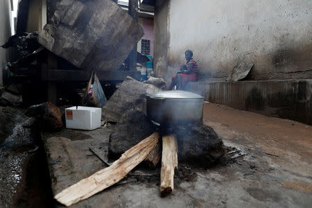 Ngwe Emilian, 31, who fled violence in the Northwestern division of Barmenda sits with her child near the house where she is staying in Yaounde, Cameroon, October 2, 2018. REUTERS/Zohra Bensemra