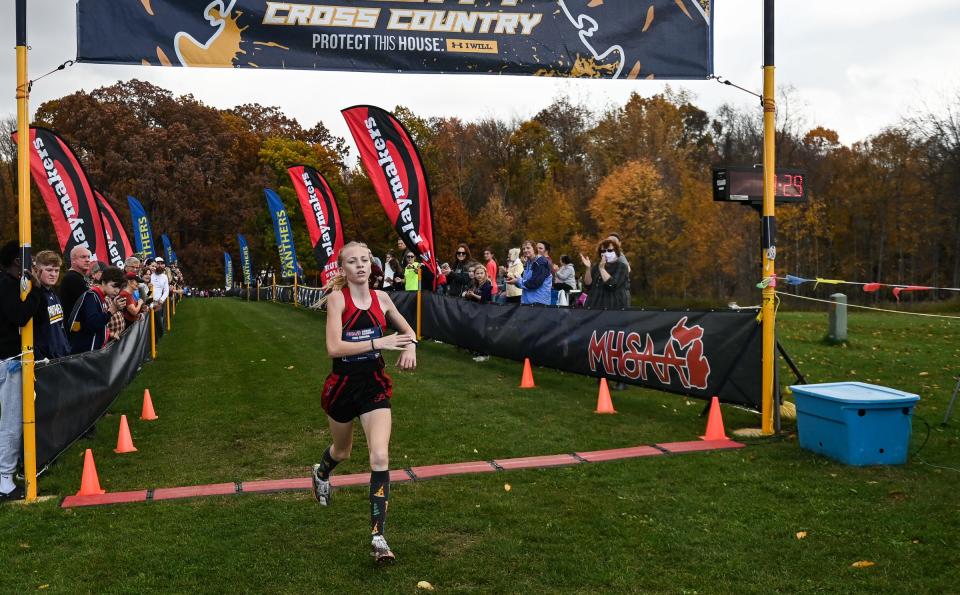 Div. 2 cross country champion Ava Schafer of St. Johns crosses the finish line with a time of 17:48.0, Friday, Oct. 27, 2023, during the MHSAA Div. 2 Cross Country regional at DeWitt High School.