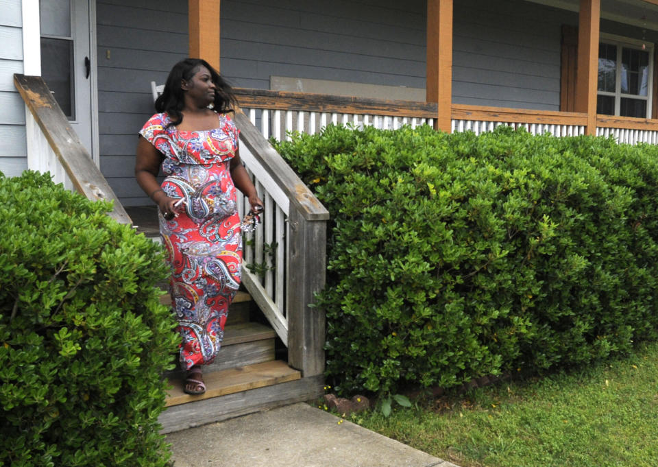 Markedia Wells is shown on April 14, 2021, leaving her home in Tuscaloosa, Ala., where she and her two sons survived a tornado a decade ago. The family still lives in the same neighborhood that was struck by a massive twister on April 27, 2011. (AP Photo/Jay Reeves)