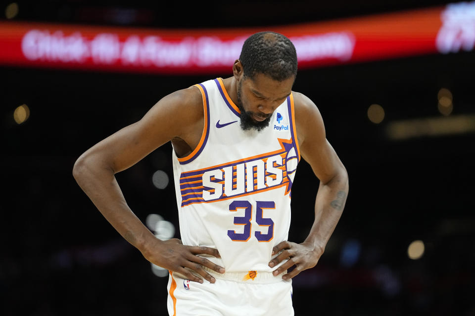 Phoenix Suns forward Kevin Durant (35) looks downward during the second half of an NBA basketball game against the Brooklyn Nets, Wednesday, Dec. 13, 2023, in Phoenix. (AP Photo/Matt York)