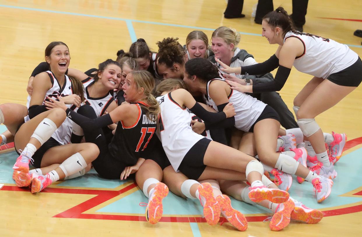 The Marlington volleyball team celebrates after its five-set win over Kenston in a Division II regional semifinal, Thursday, Nov. 2, 2023, at Alliance High School.