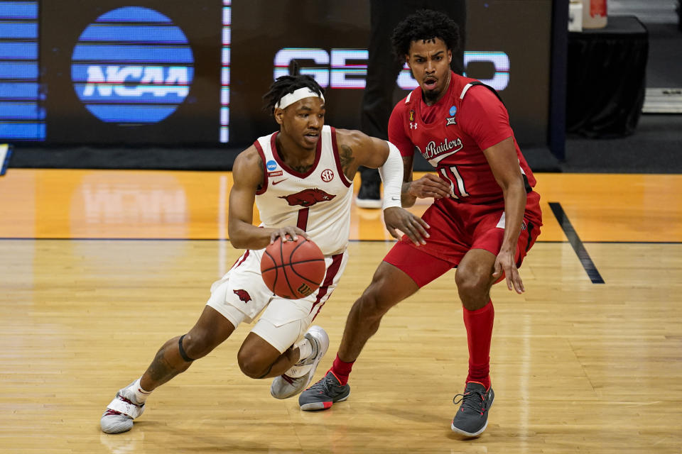 Arkansas guard JD Notae (1) drives on Texas Tech guard Kyler Edwards (11) in the first half of a second-round game in the NCAA men's college basketball tournament at Hinkle Fieldhouse in Indianapolis, Sunday, March 21, 2021. (AP Photo/Michael Conroy)