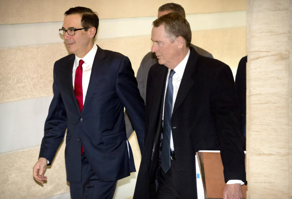 U.S. Treasury Secretary Steven Mnuchin, left, and U.S. Trade Representative Robert Lighthizer walk together as they leave their hotel in Beijing, Friday, Feb. 15, 2019. U.S. and Chinese negotiators opened talks Thursday on a sprawling trade dispute as Beijing reported its January exports rebounded despite President Donald Trump's tariff hikes. (AP Photo/Mark Schiefelbein)