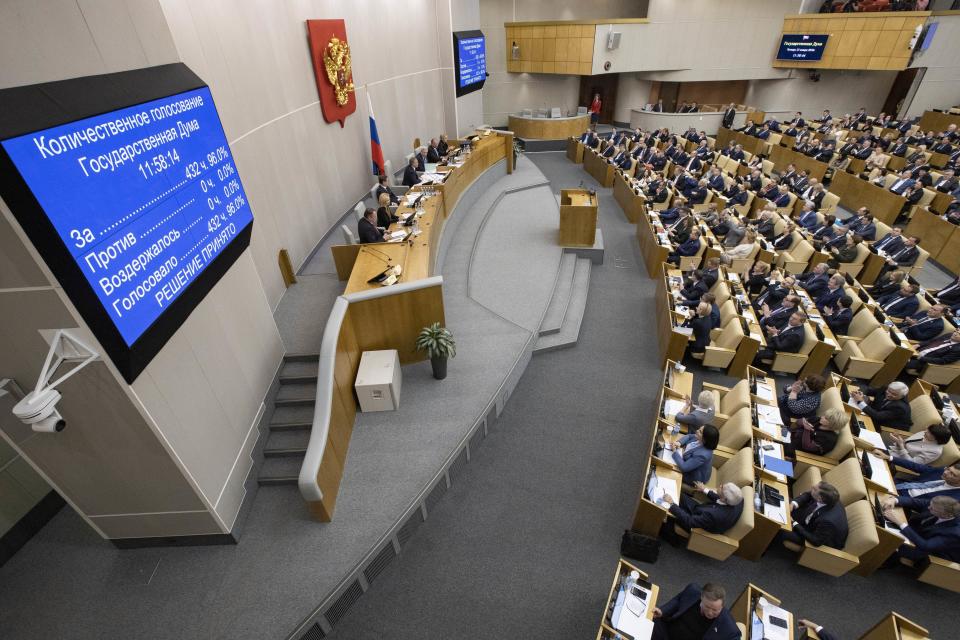 Russian lawmakers vote for Russian constitutional amendments during a session at the Russian State Duma, the Lower House of the Russian Parliamentin Moscow, Russia, Thursday, Jan. 23, 2020. Kremlin-controlled lower house of parliament, the State Duma, unanimously voted for constitutional amendments on Thursday, widely seen as President Vladimir Putin's strategy to stay in power well past the end of his term in 2024. (AP Photo/Alexander Zemlianichenko)