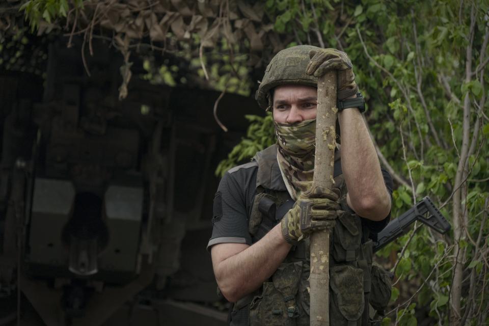 In this photo taken on Friday, April 26, 2024 and released by the Russian Defense Ministry Press Service, a Russian soldier stands by a 2A65 "Msta-B" howitzer at a position in an undisclosed location in Ukraine. (Russian Defense Ministry Press Service via AP)