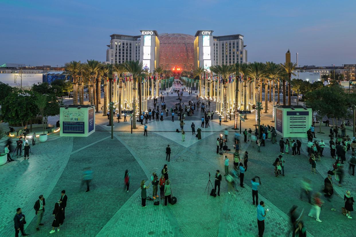 People walk outside Expo City in Dubai on Tuesday during the United Nations Climate Change Conference COP28 (AFP via Getty Images)