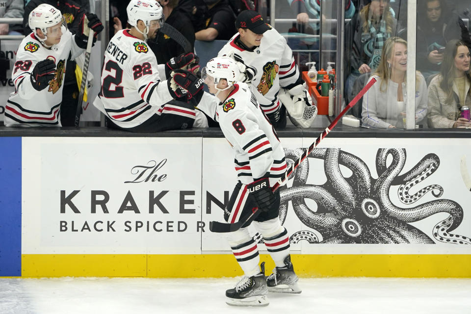 Chicago Blackhawks left wing Dominik Kubalik (8) greets teammates after he scored a goal against the Seattle Kraken during the second period of an NHL hockey game, Monday, Jan. 17, 2022, in Seattle. (AP Photo/Ted S. Warren)