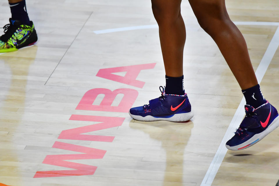 WNBA logo on the court. 